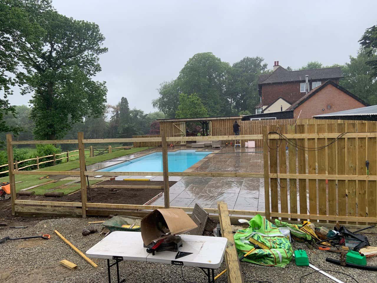 This is a photo of Bespoke custom fencing installed around a swimming pool by Fast Fix Fencing Lakenheath