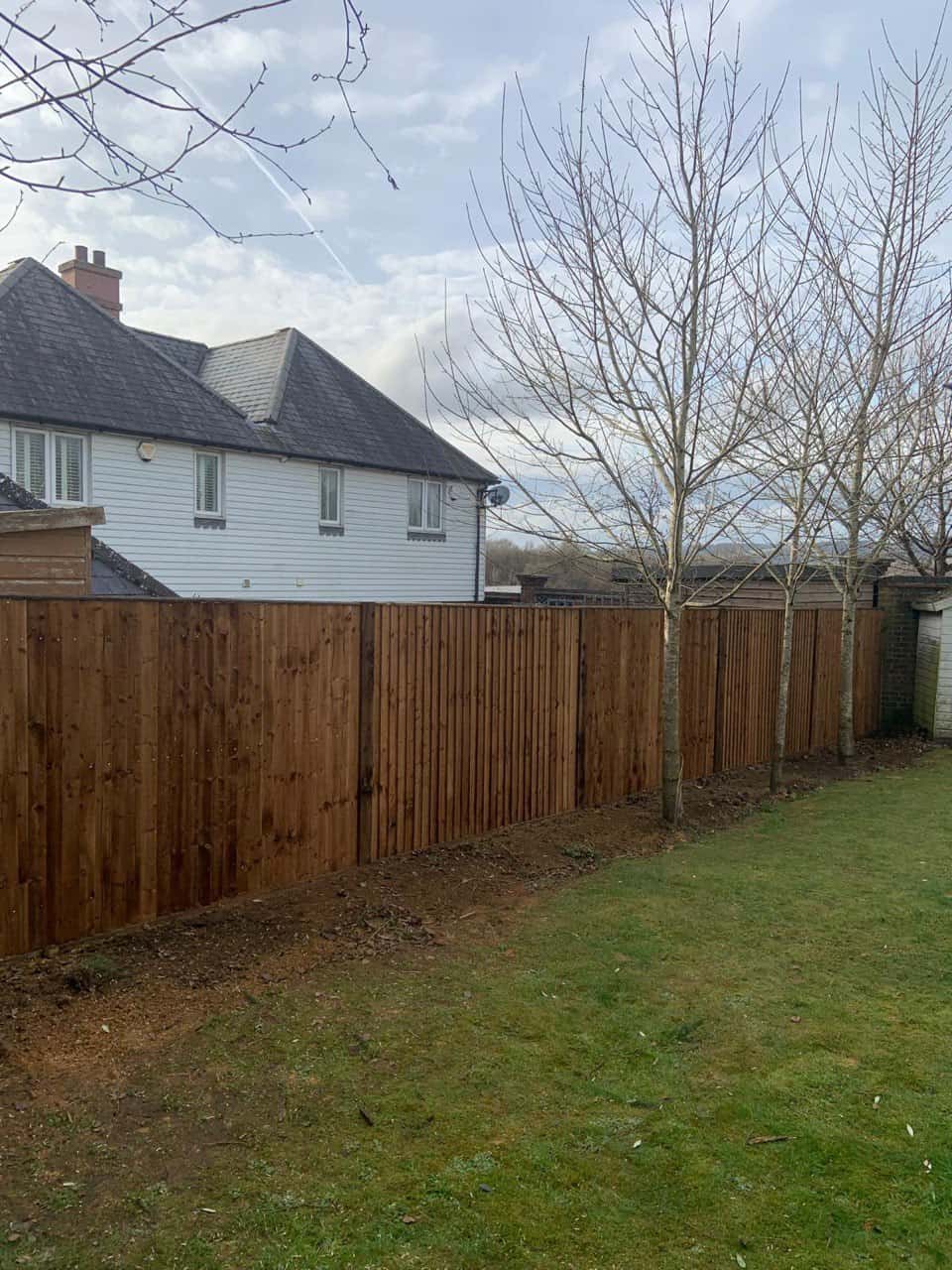 This is a photo of feather edge fencing installed in a residential properties garden by Fast Fix Fencing Lakenheath